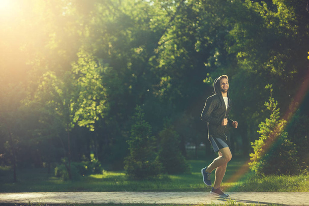 Happy man running in park  - Fotoğraf, Görsel