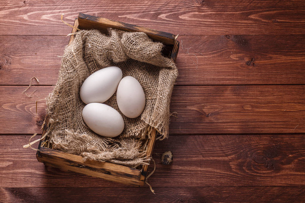 Three big fresh goose eggs in a box, copyspace - Photo, image