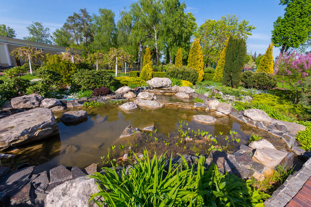 small decorative pond in a park with huge stones - Foto, afbeelding