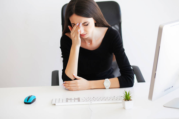 Beautiful Businesswoman suffering pain on her office. - Photo, image