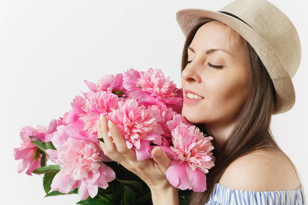 Young tender woman in blue dress, hat holding bouquet of beautiful pink peonies flowers isolated on white background. St. Valentine's Day, International Women's Day holiday concept. Advertising area - Photo, image
