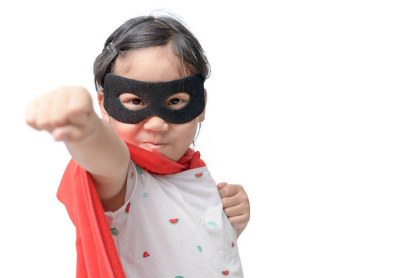 Little child plays superhero isolated on white background, Girl power concept. - Photo, Image