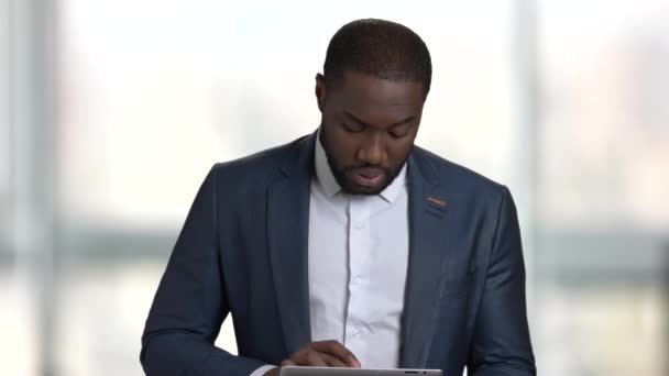 Black businessman with touchscreen tablet device. - Imágenes, Vídeo