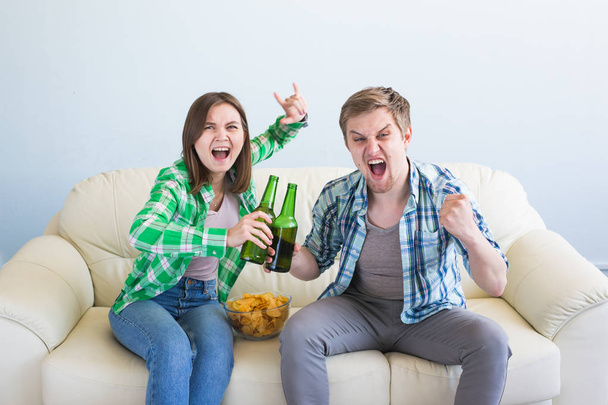 Soccer world cup concept - Couple of friends sitting in sofa watching sport game on tv - Фото, зображення