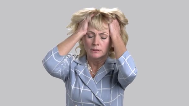 Mature blond woman feeling headache. - Footage, Video