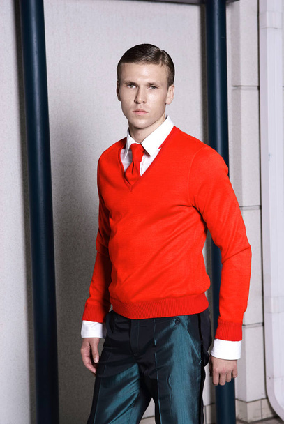 Portrait of an attractive young businessman in urban background wearing red jacket and red tie. Looking to the camera. Classic style - Фото, зображення