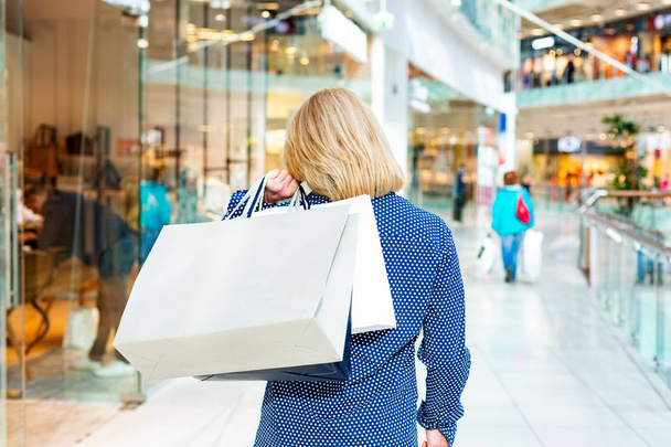 Fashion Shopping Girl Portrait. Beauty Woman with Shopping Bags in Shopping Mall. Shopper. Sales. - Photo, Image