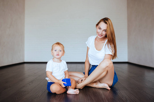 Young mother with her little son are posing. Casual lifestyle photo. - Zdjęcie, obraz