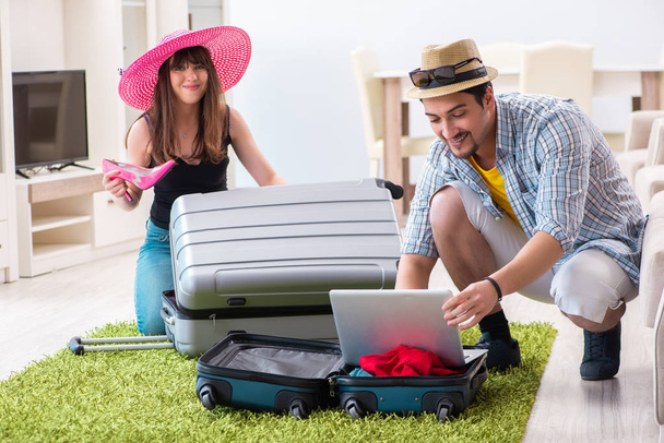 Young pair packing for summer vacation travel - Photo, Image