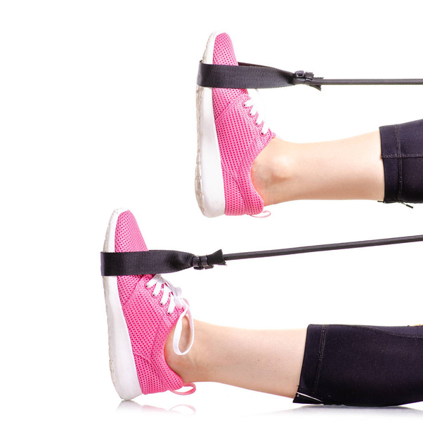 Female legs sports leggings sneakers sports exercises expander for legs - Foto, imagen