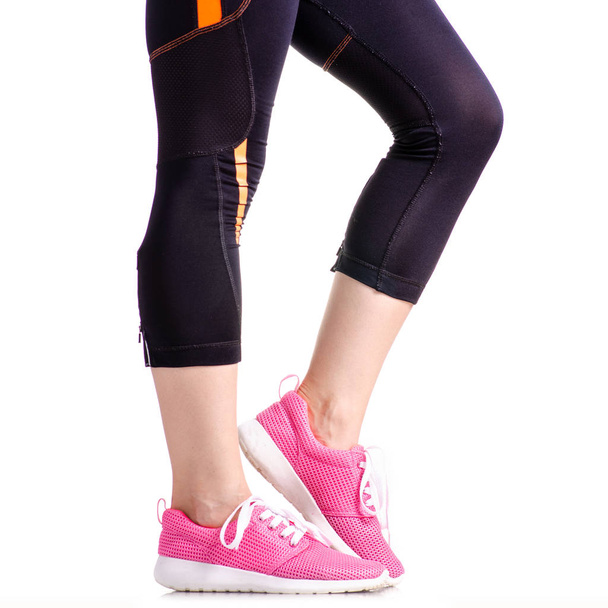 Female legs sports leggings sneakers sports exercises - Fotografie, Obrázek