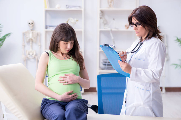 Pregnant woman visiting doctor for regular check-up - Fotoğraf, Görsel