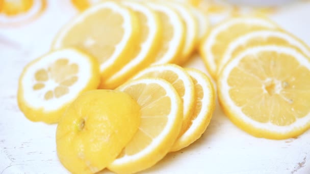 Fresh sliced lemon on a white wood cutting board - Footage, Video