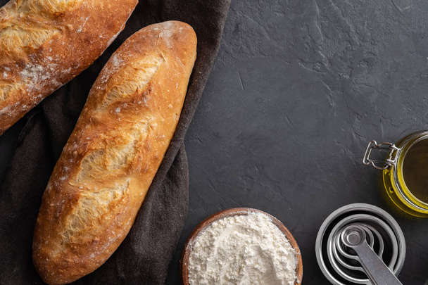 Fresh bread with ingredients on a dark background. Copy space. - Foto, Imagem