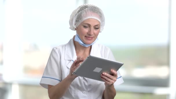 Portrait of mature female doctor using digital tablet. - Felvétel, videó