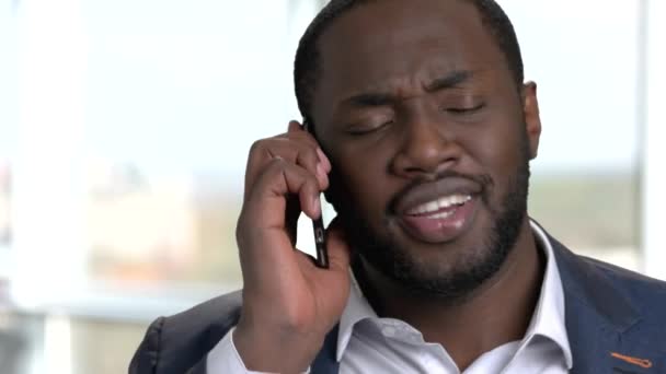 Close up portrait of black man having phone conversation. - 映像、動画