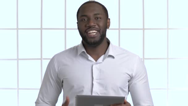 Tablet tutarak ve konuşmaya yakışıklı Afrika siyah adam portresi. - Video, Çekim