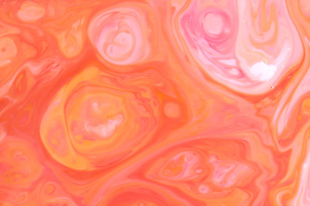 Multicolored holographic background, orange liquid spills, multicolored pattern, food colors in milk, color texture on the water, blank for the designer - Φωτογραφία, εικόνα