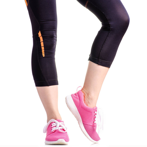 Female legs sports leggings sneakers sports exercises - Foto, immagini