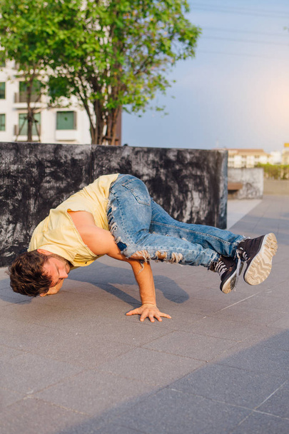 Young handsome man with beard dancing breakdance on the street - Fotografie, Obrázek
