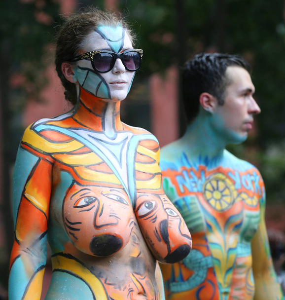 NEW YORK - JULY 14, 2018: Artists paint  fully nude models of all shapes and sizes during 5th NYC Body Painting Day featuring artist Andy Golub on Washington Square in New York - Photo, image