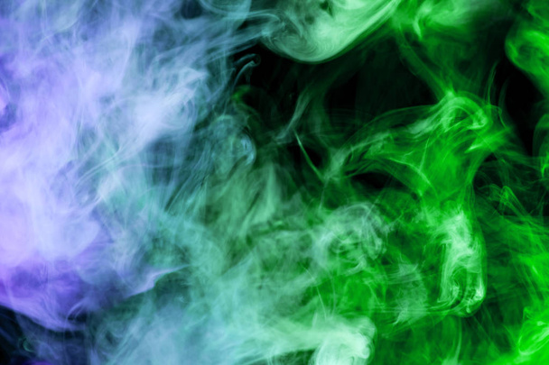 Blue and green smoke on a black isolated background. Background from the smoke of vape - Φωτογραφία, εικόνα