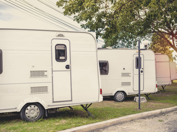 White caravan camping trailer cars, motorhomes parking in the garden. - Photo, Image