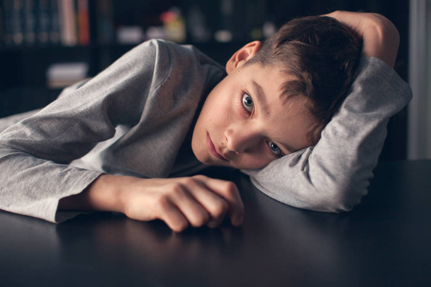 Sad boy. Depressed teenager at home. Problems at family - Foto, Imagem