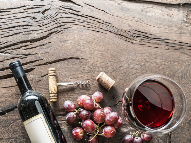 Wine glass, wine bottle and grapes on wooden background. Wine tasting. - Foto, Imagem