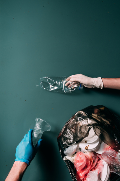cropped shot of man and woman in latex gloves cleaning water from garbage, ecology protection concept - Fotoğraf, Görsel