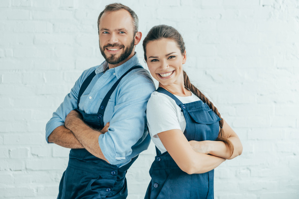 smiling confident workers in uniform posing with crossed arms - Photo, Image