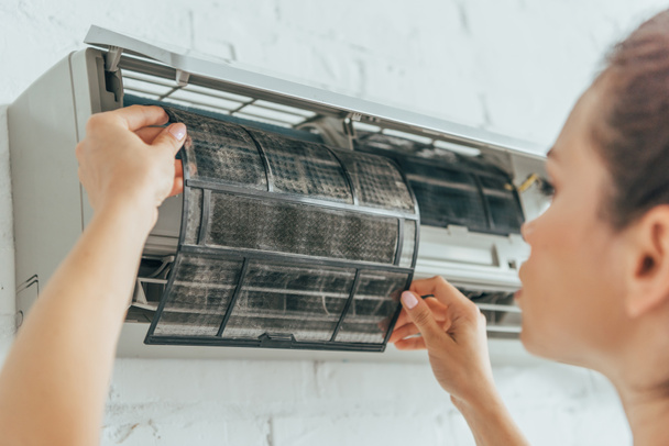 selective focus of female worker repairing air conditioner - Fotoğraf, Görsel