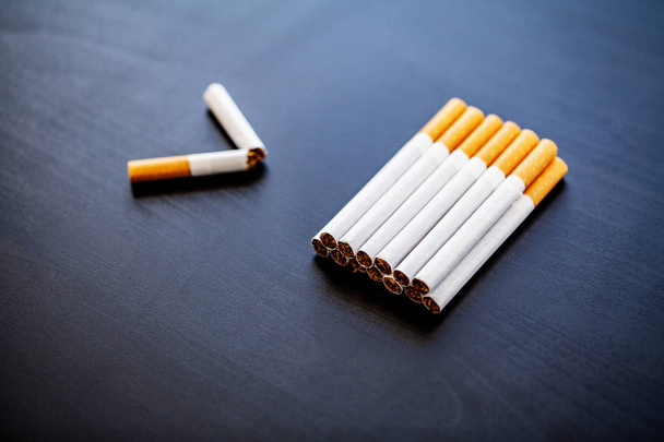 Stop smoking concept on background with broken cigarettes. Heap of cigarettes. No smoking. - Photo, Image