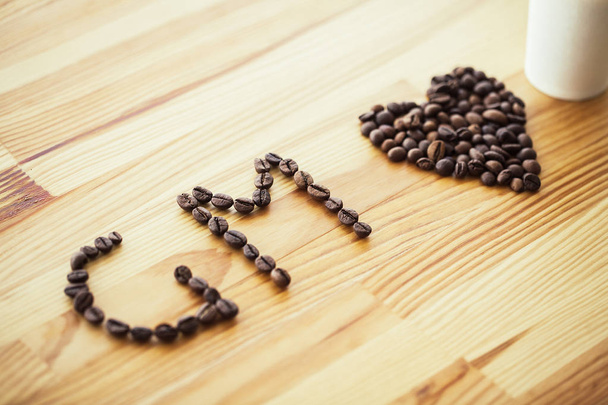 Good Morning. Coffee Time. Coffee to go and beans on a wooden background. - Photo, Image