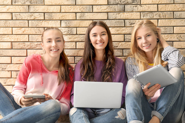 teenage girls with modern devices  - Фото, зображення