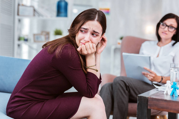 Sad woman crying while visiting her psychologist - Photo, image