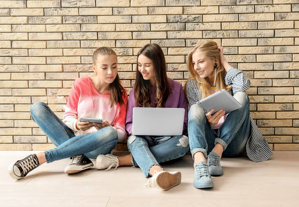 teenage girls with modern devices   - Фото, изображение