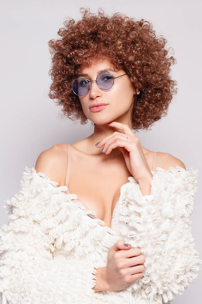 Portrait of smiling young black woman. Portrait of a beautiful young woman with African American afro haircut and glamor makeup. Studio shot. Attractive girl wearing eyeglasses. - Photo, image