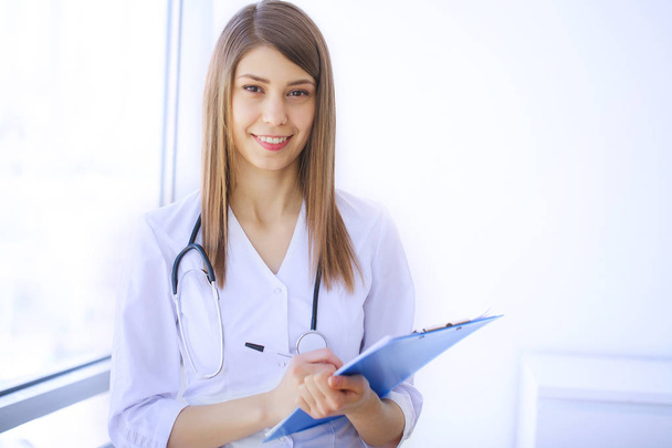 Healthcare Professional. Young female doctor on modern clinic office. - Φωτογραφία, εικόνα