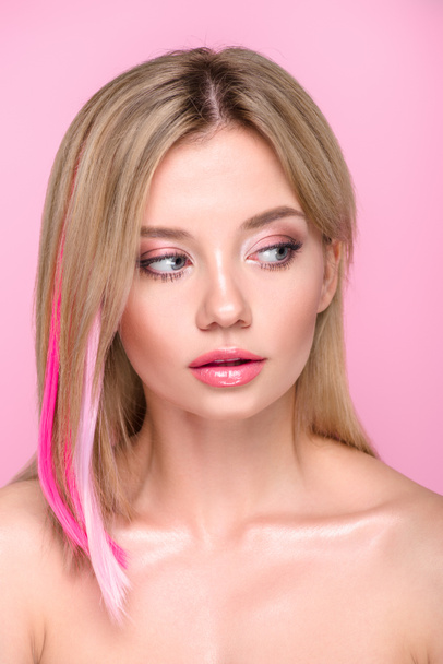 close-up portrait of beautiful young woman with colorful hair strands isolated on pink - Foto, immagini