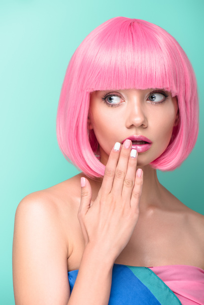 shocked young woman with pink bob cut covering mouth with hand isolated on turquoise - Фото, зображення