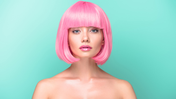 confident young woman with pink bob cut looking at camera isolated on turquoise - Fotografie, Obrázek
