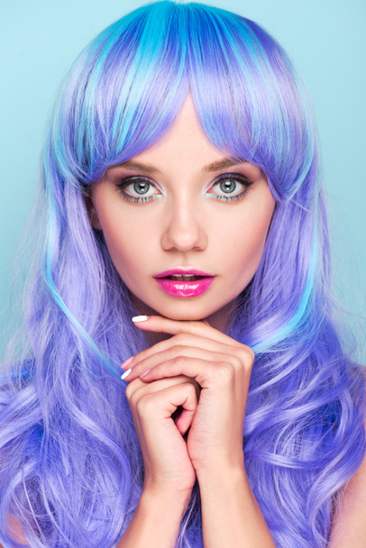 beautiful young woman with blue hair looking at camera isolated on blue - Foto, Imagem