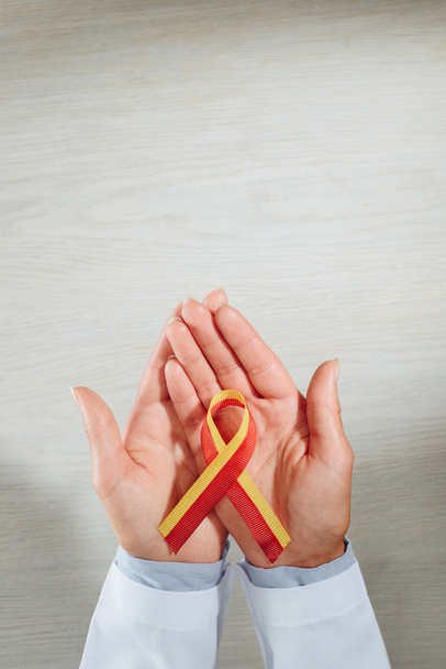 cropped image of female doctor holding ribbon, world hepatitis day concept - Photo, Image
