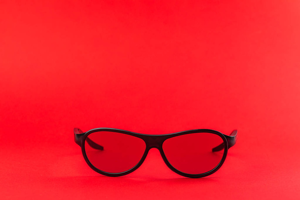 Modern fashionable and office spectacles isolated on red background. - Photo, Image