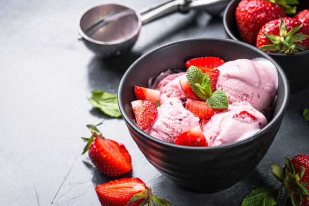 Strawberry ice cream with fresh berries on black.  - Photo, Image
