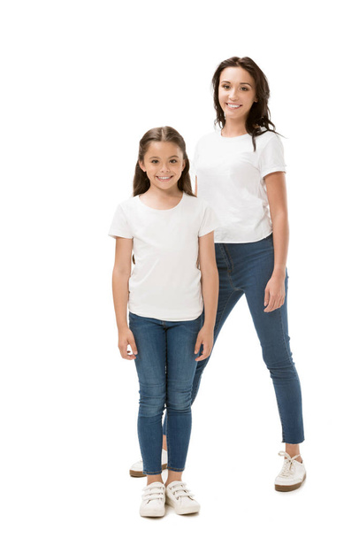happy mother and daughter in white shirts looking at camera isolated on white - Valokuva, kuva