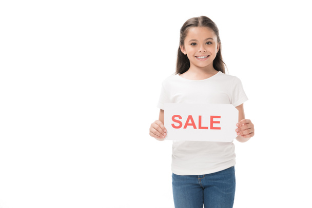 portrait of smiling kid with sale banner in hands isolated on white - Fotografie, Obrázek