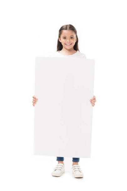 smiling child with blank banner in hands looking at camera isolated on white - Zdjęcie, obraz