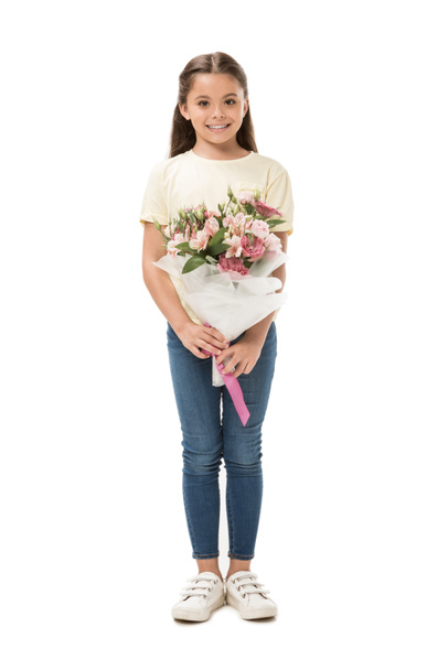 smiling kid with bouquet of flowers looking at camera isolated on white - Fotografie, Obrázek